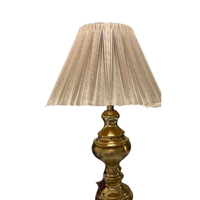 Pair of vintage Stiffel solid brass urn-style lamps in classic Hollywood Regency style. Featuring pleated fabric shades,...