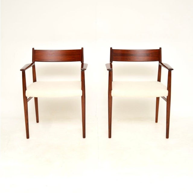 A stylish and extremely well made pair of Danish vintage carver armchairs by Arne Vodder. They are the model 418a chairs,...