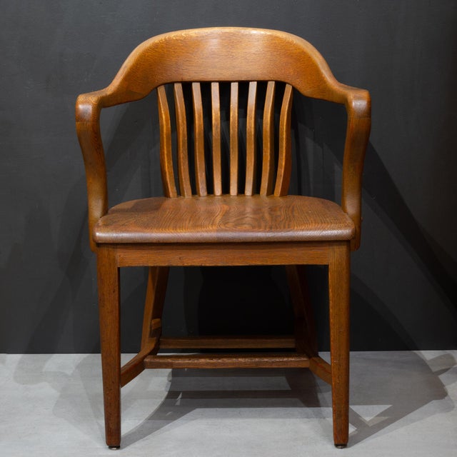 ABOUT A set of four antique bow-back Windsor style banker's or library chairs styled by the Phoenix Chair Company. Phoenix...