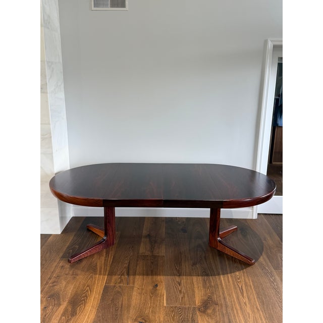 An exceptional vintage Danish Modern expandable dining table by Faarup Møbelfabrik, crafted in richly figured rosewood and...