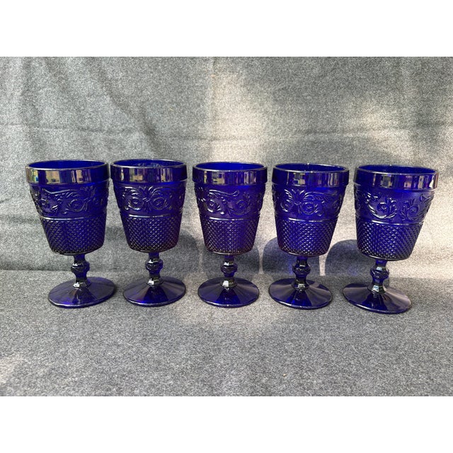Pretty, vintage set of 5, ornate, cobalt blue pressed glass goblets. No chips or cracks. They measure 3 1/2" in diameter...