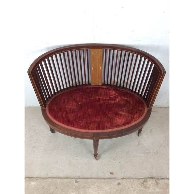 This Edwardian settee features hardwood construction, beautiful mahogany finish with spindled back, two mother of pearl...