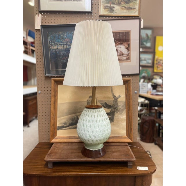 Ceramic Base is off White Tinted Green as Pictured. Pleated Tall Lamp Shade is Included. Operational Ability Unknown....