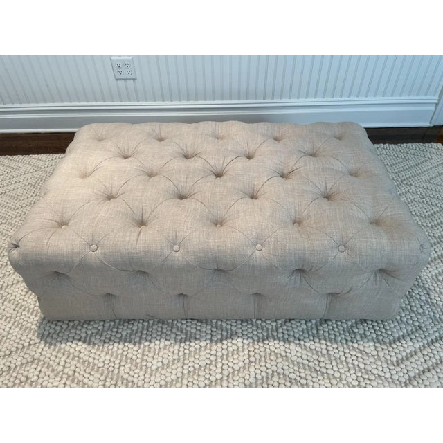 The neutral fabric, stylish tufting and hidden wheels makes this lovely ottoman visually appealing and highly functional....