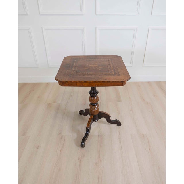 A remarkable Italian mid-19th century Rolo center table, celebrated for the refined marquetry tradition of the renowned...