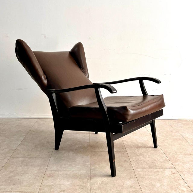 Pair of reclining armchairs, dark wood structure and skai padding, Italian manufacture, 1950s Measurements: 93 x 65 x 73...