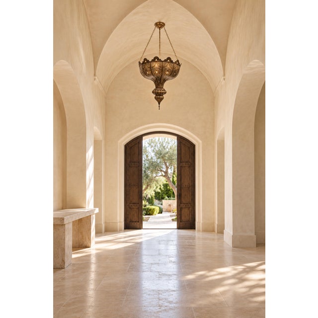 An impressive vintage Moroccan brass chandelier, handcrafted circa 1960, combining intricate pierced metalwork with a...