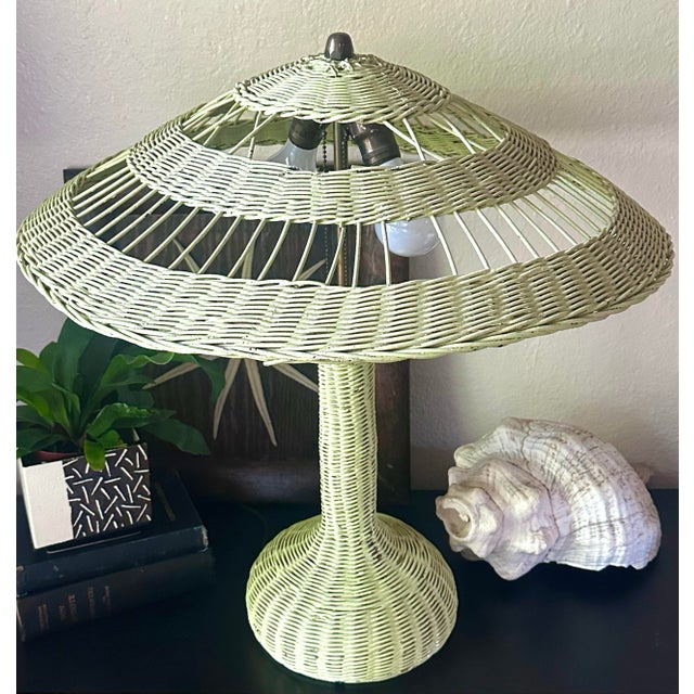 A rare and charming antique wicker table lamp in the style of Heywood-Wakefield, featuring a beautifully woven body and...