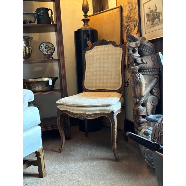 This gorgeous antique French-style carved side chair will add charm to any space! The wood is beautifully carved, and the...