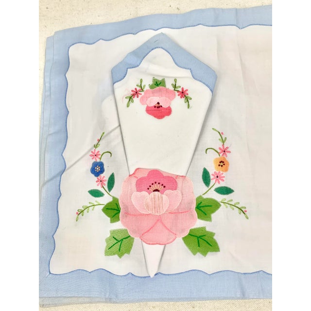 Beautiful vintage appliqué placemats and napkins. Features a floral design. There are six placement and six napkins....