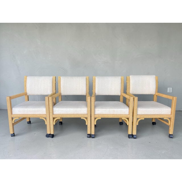 A stylish set of four wrapped rattan dining armchairs by Henry Link, featuring a classic Palm Beach / coastal design with...