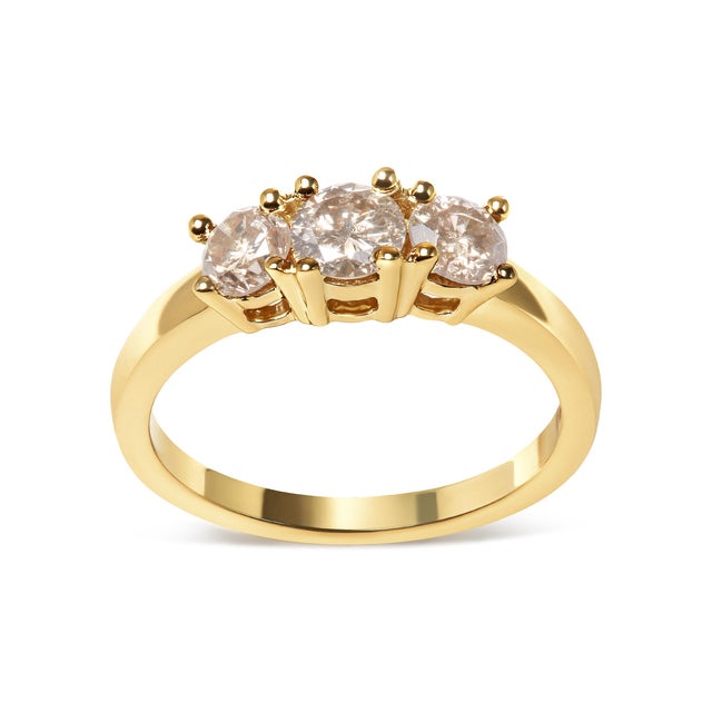 Make a bold statement with this magnificent champagne diamond 3-stone band ring. Expertly crafted from radiant 10K yellow...