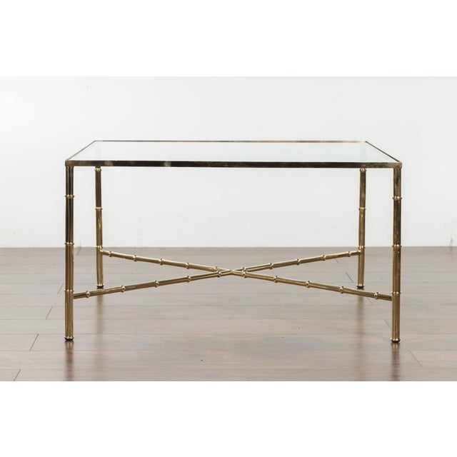 An Italian vintage brass coffee table from the mid-20th century, with glass top. Created in Italy during the midcentury...