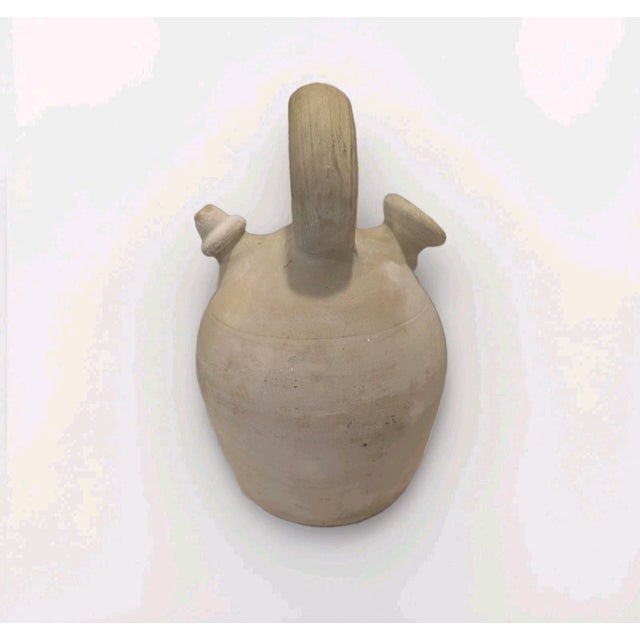 Traditional Spanish botijo water jug handcrafted from unglazed porous clay in Agost, Alicante, Spain. This distinctive...