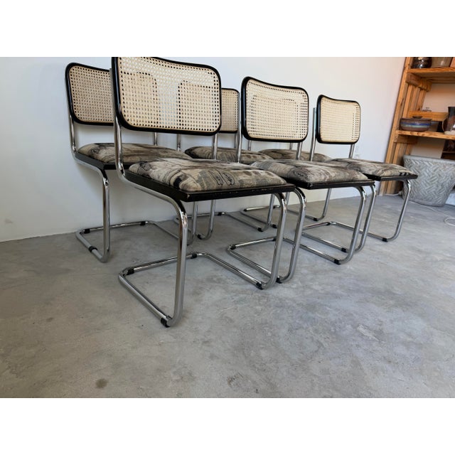 Stylish vintage Italian Marcel Breuer-style “Cesca” dining chairs featuring iconic cantilever chrome frames paired with...