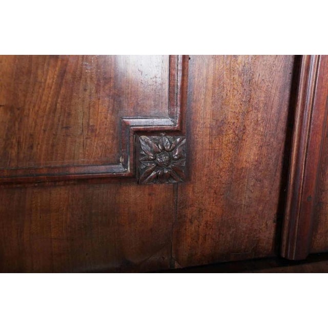 Solid mahogany veneered body. Cast fittings. Upper two-door section with shelves and internal drawers and lower drawer...