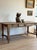 A substantial 19th century French dining table with a beautifully time-softened surface, the wood worn smooth over years...