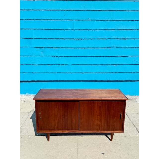 Marvelous compact credenza here. Solid Walnut with some sweet mid century modern pulls and simple sleek design. In good...