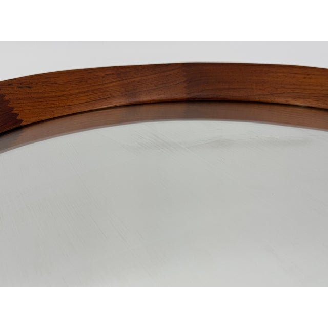 A mirror * Round teak mirror * Produced by Glass & Wood Hovmantorp, Sweden * Vintage from the 1960s * Crystal glass...