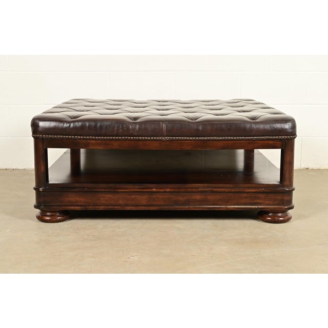 A gorgeous Chesterfield style cocktail table or ottoman By Bernhardt Early 21st Century Tufted brass-studded brown...