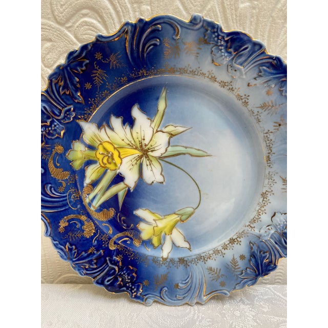 This is such a beautiful antique circa 1890s flow blue hand painted daffodil plate that is scalloped on the edges in an...
