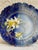 This is such a beautiful antique circa 1890s flow blue hand painted daffodil plate that is scalloped on the edges in an...