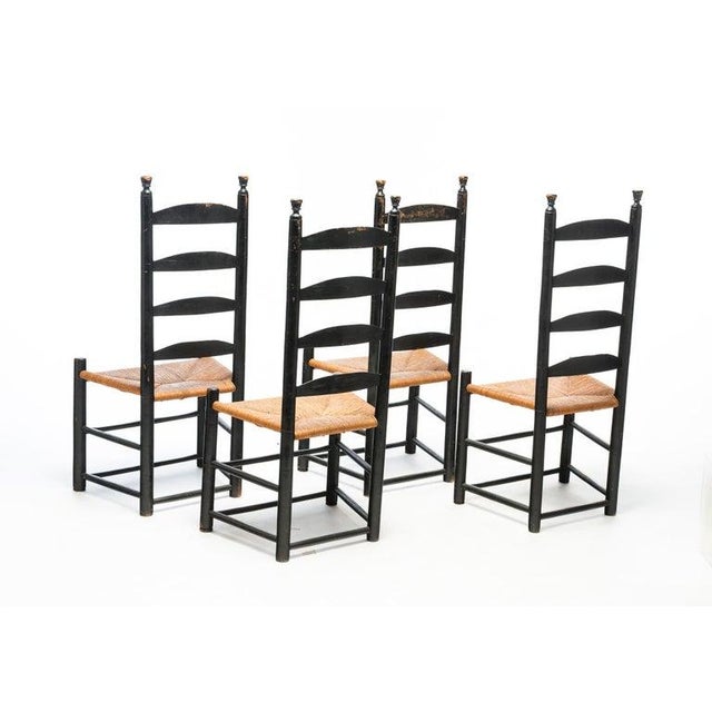 FOUR PAINT-DECORATED LADDERBACK SIDE CHAIRS. American, 19th Century. Mixed woods. Plain turnings with torch finials, four...