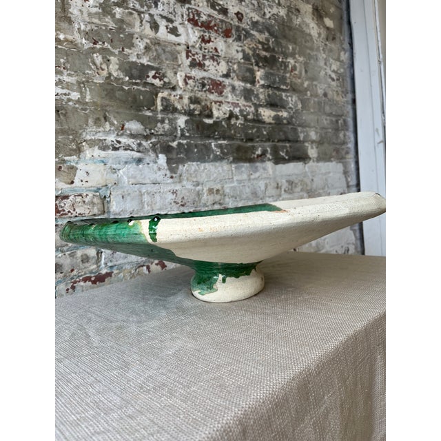 "A sculptural statement piece for any tabletop. This handcrafted ceramic bowl features a striking yin-yang glaze in...