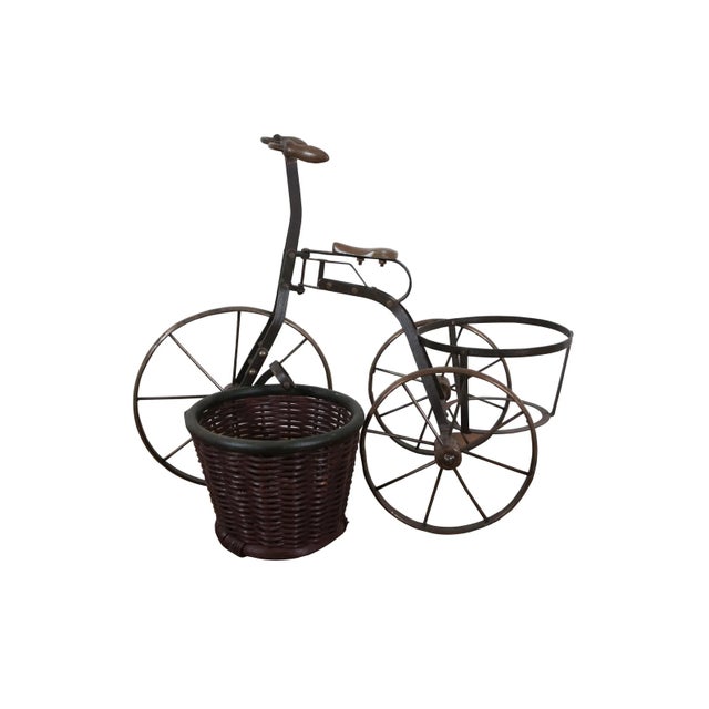 Late 20th century metal tricycle shaped plant stand with wooden handles and seat, and cylindrical woven planter basket...