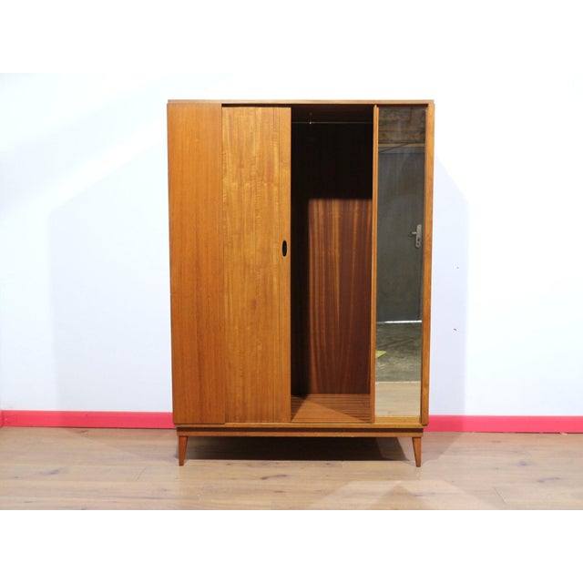 Introducing this Mid Century Modern Vintage Teak Tripple Armoire with Tambour Door by Austinsuite, a stunning addition to...