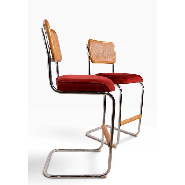 Chic pair of 1970's vintage bar height stools, by Daystrom. The stools feature a tubular chrome frame with an upholstered...
