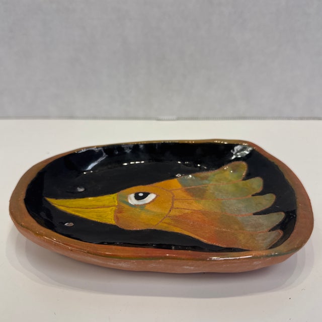 Small pottery wall plaque or catchall with bird by Martha's Vineyard potter Washington Ledesma. Signed on reverse. Two...