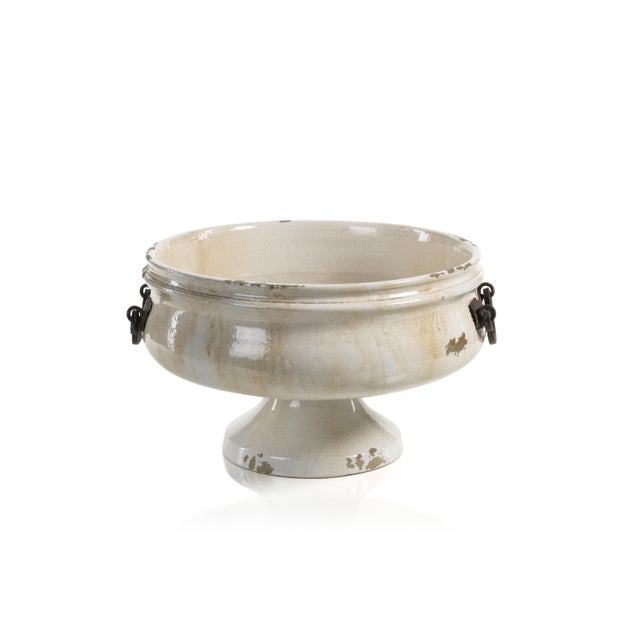 Add an elegant accent piece to your home using the Corsica Pedestal Bowl With Iron Handles. Made from distressed beige and...