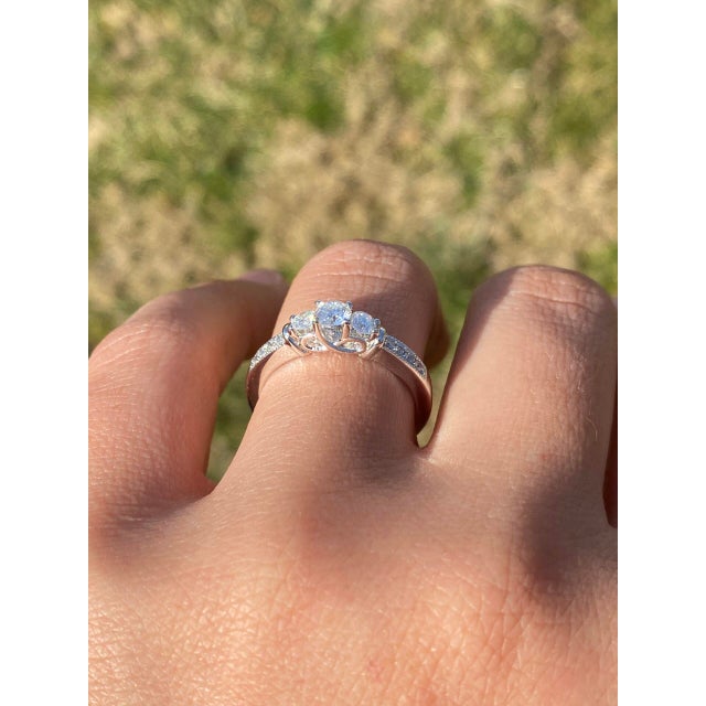 The Gateshead: Contemporary Past Present Future Natural Diamond Ring in White Gold. This elegant ring highlights a central...