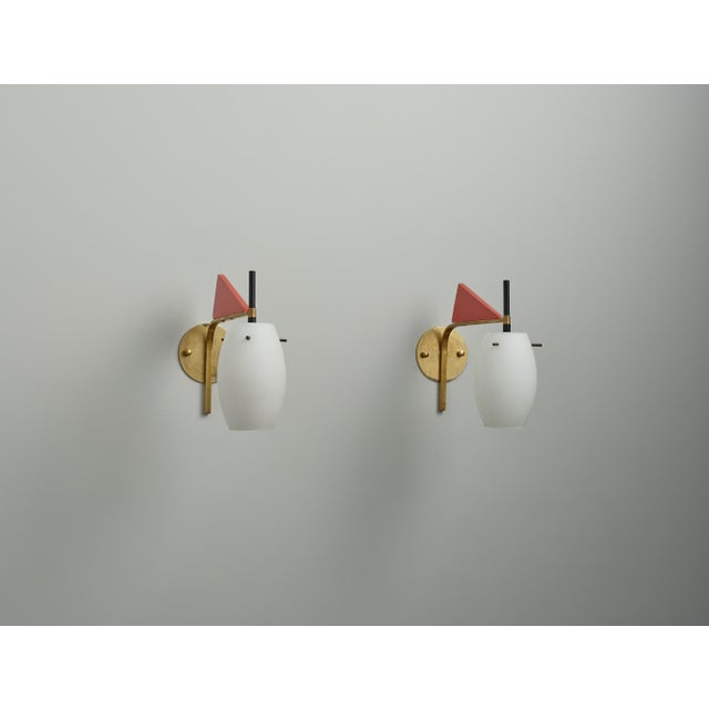 This pair of mid-century modern wall sconces exemplifies the elegance and innovation of 1950s Italian design. Each sconce...