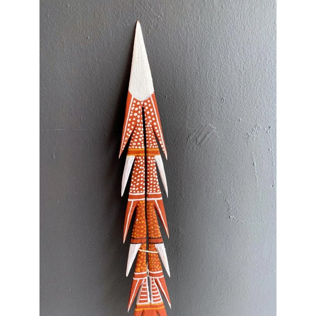 Title: A ceremonial spear with clan design paint Artist: John Martin Tipungwuti DOB: 18/01/1969 Medium: Ocher paint on...