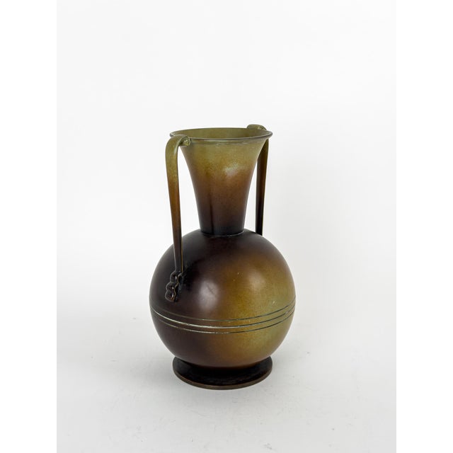 An elegant and highly decorative patinated brass vase designed by Gunnar Ander for Ystad Metall, Sweden, during the 1950s....