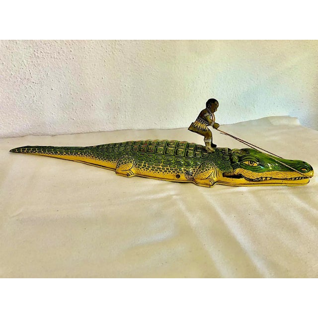 Manufactured in the mid 1930s by J. Chein & Company in Harrison, New Jersey, this vintage wind-up toy depicts a boy riding...