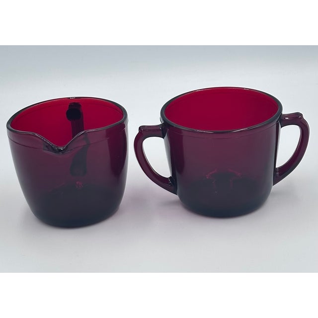 Elevate your coffee service with this delightful creamer & sugar set of Anchor Hocking dishes in the stunning Baltic Royal...