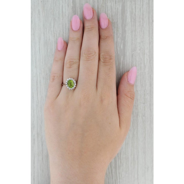 Gemstone Information: - Natural Peridot - Carats - 2.15ct Cut - Oval Brilliant Color - Light Green - Natural Diamonds -...