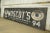 Reclaimed movie set sign made of aluminum in black, white, blue, brown, and yellow colors. The sign reads "Est. 1915,...