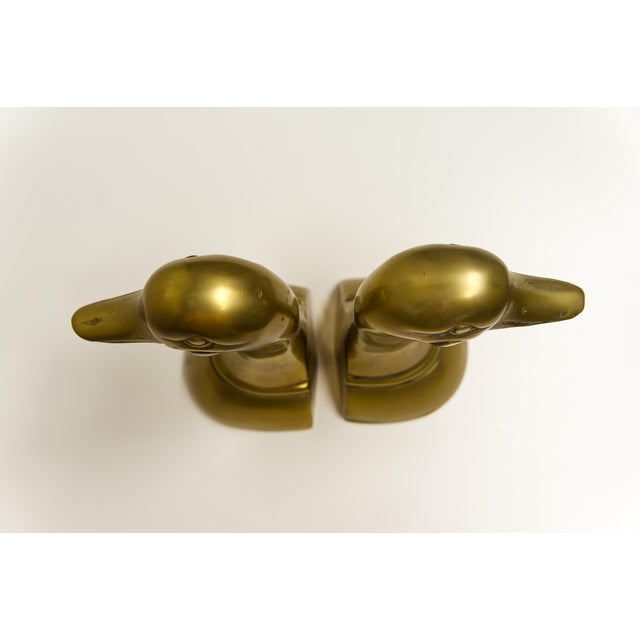 A pair of late 20th century cast brass duck head bookends. Made in Korea.