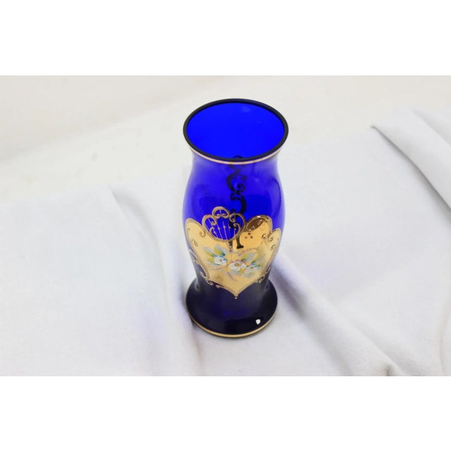 This piece is made of blue cobalt glass. It was hand painted in Czechoslovakia.