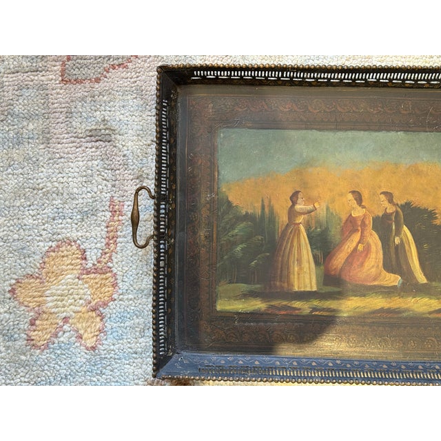This is an antique metal tin tray. It depicts "Drei Damen in Landschaft". It means Three Ladies in a Landscape". It is...
