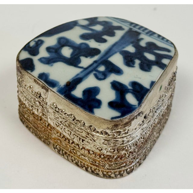 Vintage Chinese porcelain Shard box with blue and white floral pattern to top and stamped design to metal base. Age wear.
