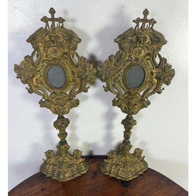 19th century pair of ornate gilded relicquaries made of brass with a gilt finish. The feature highly decorative Baroque or...