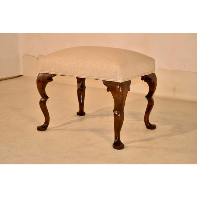 Circa 1900 walnut stool with a double cabriole leg from England. This is a wonderful stool with a gorgeous profile from...