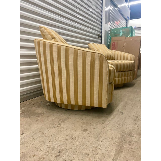 Mid-Century Modern / Hollywood Regency Low-profile barrel-back (or tub silhouette) featuring deep, integrated vertical...