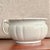 An authentic antique chamber pot by J&G Meakin, crafted in England from durable ironstone china. This piece showcases the...