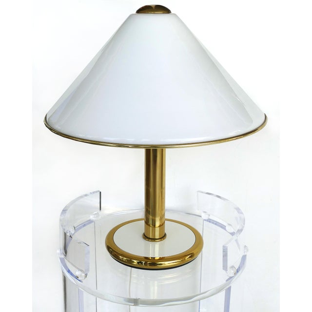 Offered for sale is a 1984 Italian Glass and brass table lamp by F. Fabbian. The base and shade are glass with brass trim...